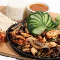 Fajita Mixta/ Mixed Fajitas · chicken and staek with pepper and onion served with tortillas.