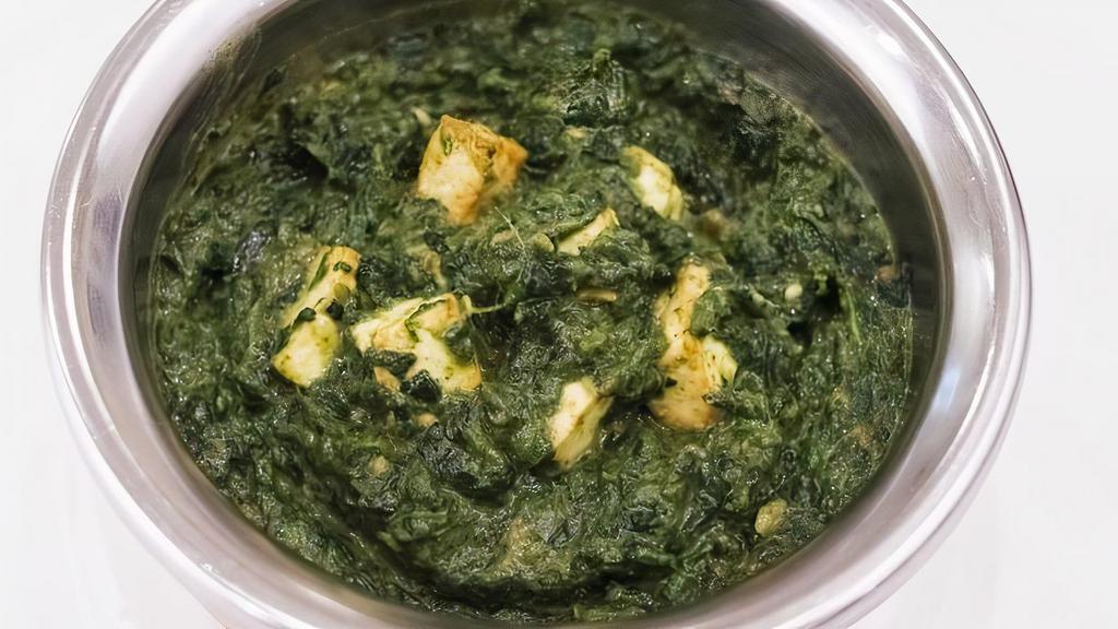 Palak Paneer · Cubes of homemade cheese smothered in freshly ground spinach with garlic & herbs.