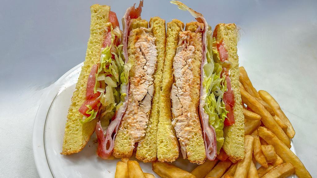 Dominican Club Sandwich · Choice of chicken or pork with ham. Swiss cheese, lettuce and tomato on Texas toast bread with mayo and ketchup comes with fries.
