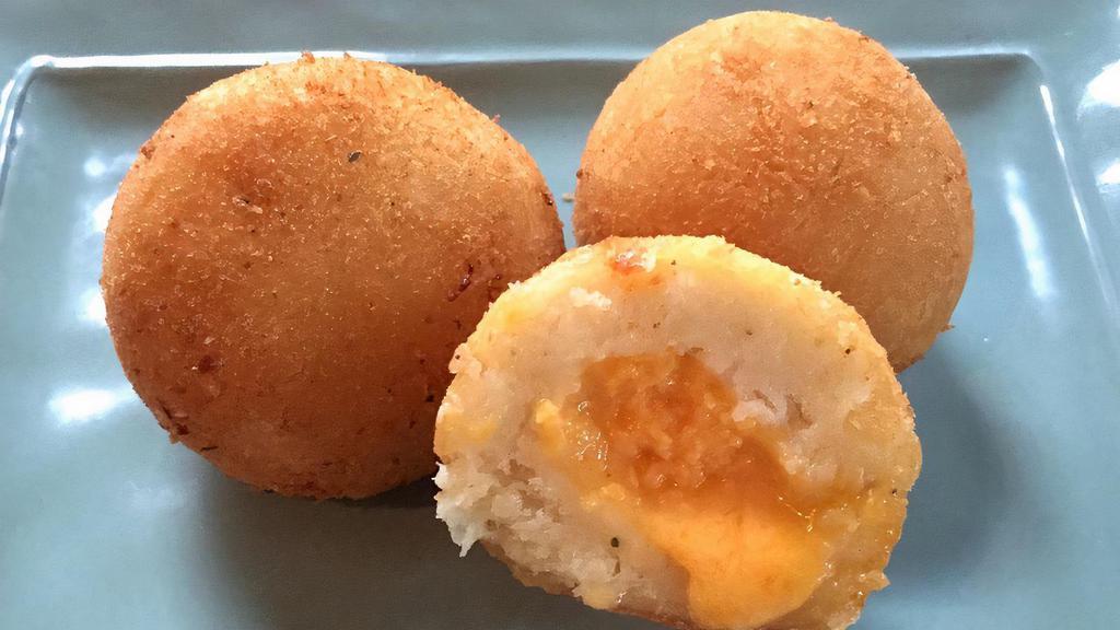 Bola De Yuca Rellena · Fried yuca balls filled with cheese.