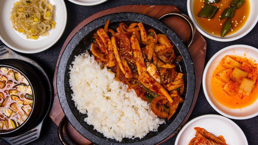 Spicy Squid Over Rice (돌판오징어덮밥) · Spicy squid over rice on sizzling stone pan.

* Includes rice and various side dishes.