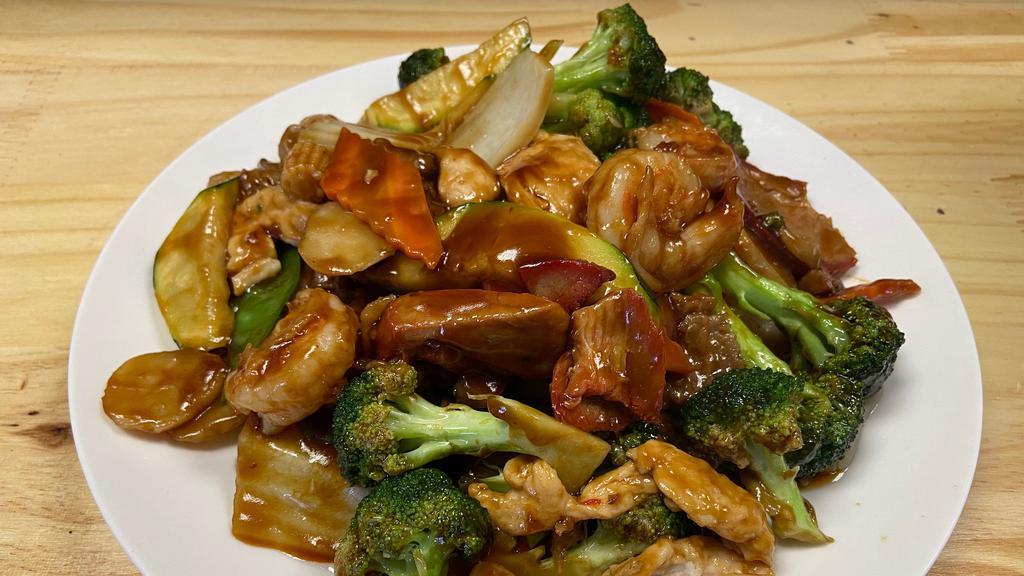 Happy Family · Scallops, shrimp, chicken and beef sautéed with fresh broccoli, water chestnuts, Napa, peapods, baby corn, carrots and mushrooms in a brown garlic sauce.