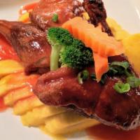 Mango Duck · Crispy roasted half duck sauteed with ripe mango in a homemade sweet and sour sauce.  Served...