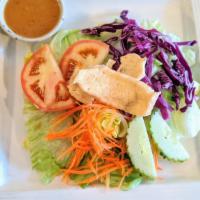 Thai Salad · Lettuce, tomatoes, cucumbers, carrots, and red cabbage topped with fried tofu. Served with p...
