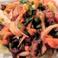 Duck Salad · Mild. Crispy duck with red onions, scallions, pineapple, carrots, tomatoes and cashews in a ...