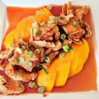 Mango Chicken · Crispy fried chicken served over ripe mango with a homemade sweet and sour sauce