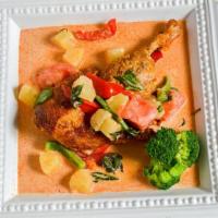 Curry Duck · Spicy. Crispy roasted duck topped with tomatoes, pineapple and bell peppers in a red curry s...