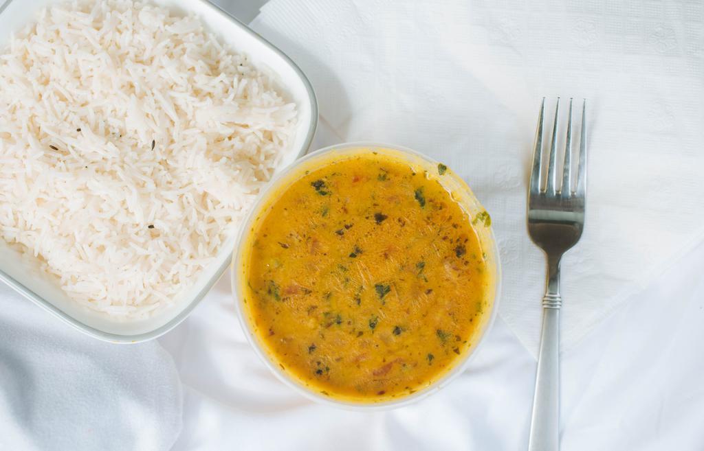 Tadka Daal · Yellow Lentils  cooked till soft onions, tomatoes and spices with tempering of cumin seeds