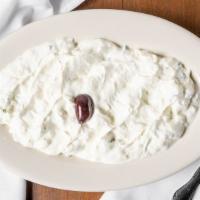 Tzatziki · Vegetarian. Greek yogurt, cucumber, garlic, served with pita.