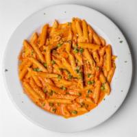 Penne A La Vodka · penne tossed in a tomato cream sauce with peas and black pepper.  with grilled chicken and s...