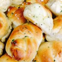 Garlic Knots 6 · 6 pieces Soft and toasty garlic knots, covered in Parmesan cheese and served with marinara s...