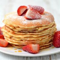 Strawberry Blonde Pancakes · Satisfying pancakes topped with strawberries and bananas.