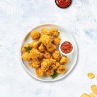 Chicken Popcorn · Bite-size pieces of chicken breaded and fried until golden brown.