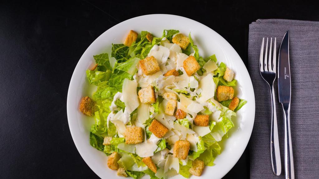 Caesar Salad · Romaine hearts, shaved parmesan, croutons, Caesar dressing.