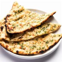 Vegan Garlic Roti · Vegan. Traditional bread baked in a tandoori oven and garnished with fresh chopped garlic.