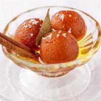 Gulab Jamun (2 Pcs.) · Traditional Indian donut holes soaked in sweet rosewater syrup. Two pieces.