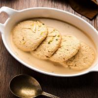 Rasmalai (2 Pcs.) · Traditional Indian paneer cheese soaked in sweet and creamy milk.