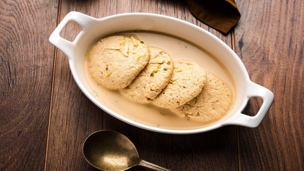 Rasmalai (2 Pcs.) · Traditional Indian paneer cheese soaked in sweet and creamy milk.