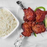 Lamb Chop Tandoori · Lamb chops marinated in spices and cooked in the tandoor. Served over a bed of bell peppers ...