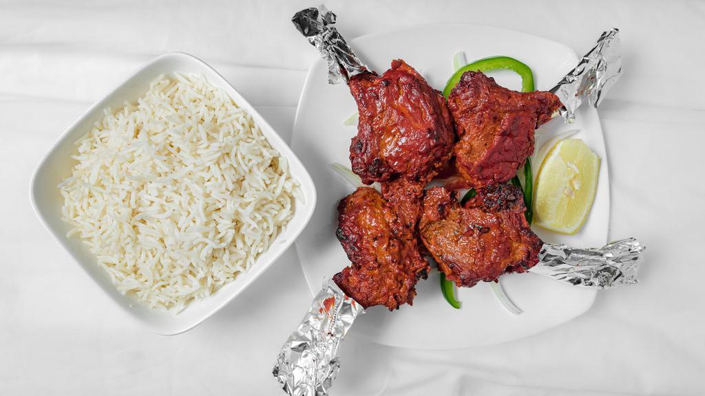 Lamb Chop Tandoori · Lamb chops marinated in spices and cooked in the tandoor. Served over a bed of bell peppers and onions.