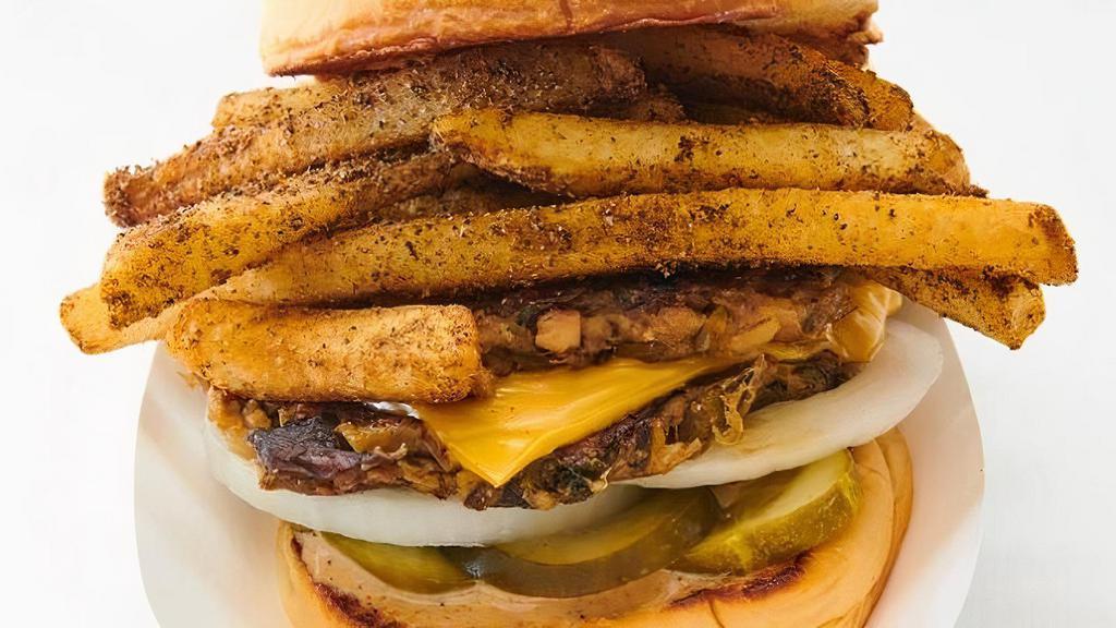 Harlem Jerk W/ Veggie · Home-made, award-winning veggie and grain patties, American cheese, pickles, and onions,  topped with jerk fries and jerk mayo.. Allergy info: contains nuts.
