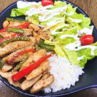 Chicken Teriyaki Over Rice · Steamed white rice topped with tender strips of grilled chicken, and assorted vegetables in ...