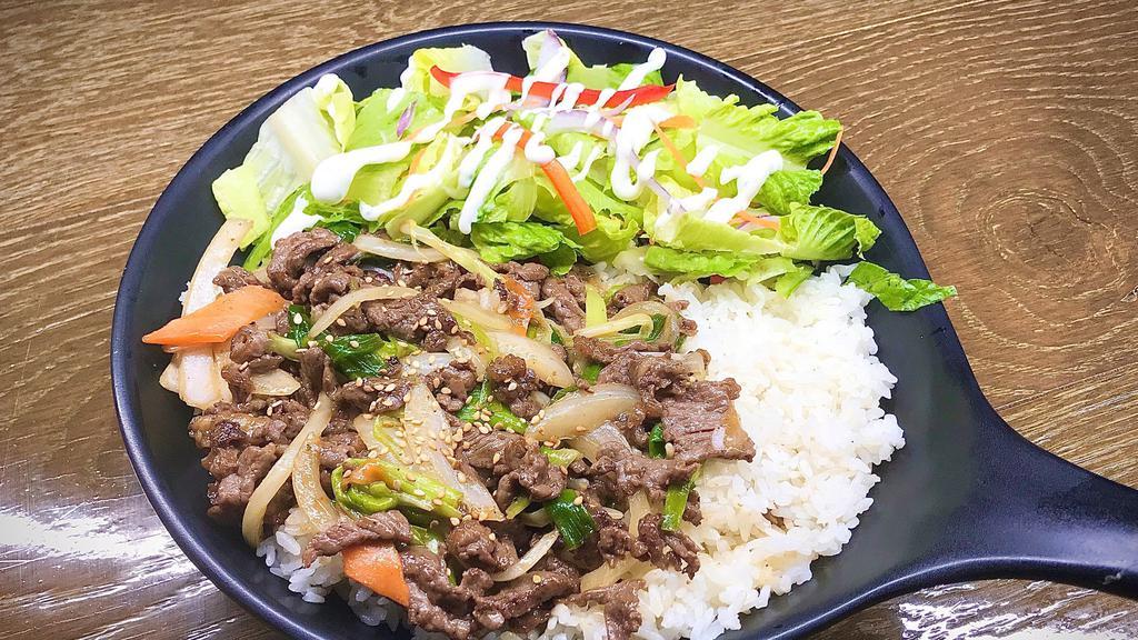 Bulgogi Over Rice · Steamed white rice topped with Korean style marinated beef with assorted vegetables.