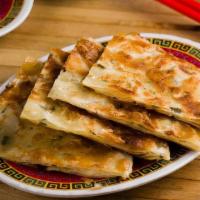 Scallion Pancakes (V) · Wheat flour wrappers mixed with scallions and pan fried. Vegan. (4 pieces)