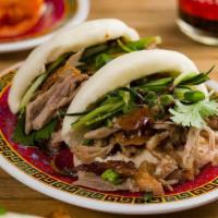 Peking Duck Buns · Steamed buns filled with Peking duck, hoisin sauce, cucumber, scallion, and cilantro (2 piec...