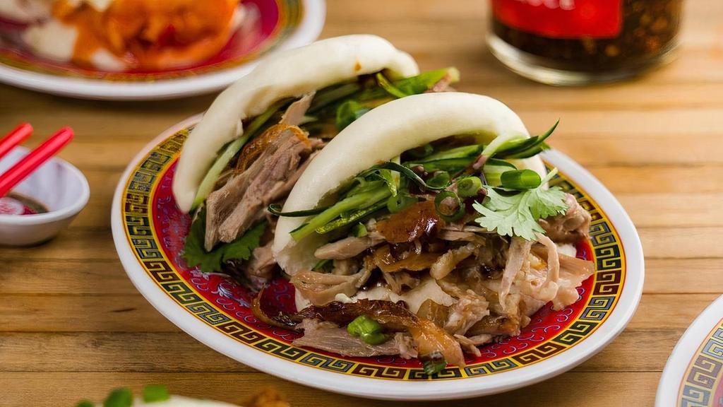 Peking Duck Buns · Steamed buns filled with Peking duck, hoisin sauce, cucumber, scallion, and cilantro (2 pieces).