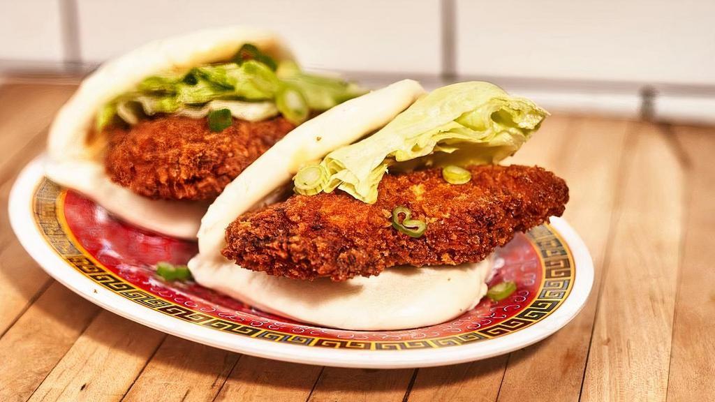 Crispy Chicken Buns · Steamed buns filled with panko crusted chicken, iceberg lettuce, scallion, and creamy sesame sauce (2 pieces).