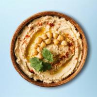 Easy Hummus · Chickpeas boiled till soft, mashed with tahini, garlic, and lemon juice, topped with olive o...