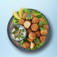 Falafel Fritters (3 Pcs) · Mashed chickpea prepared with garlic, onion, parsley, cilantro. herbs & spices over salad.