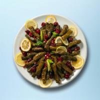 Wrapped Grape Leaves · Grape leaves Stuffed with vegetables, rice, herbs & spices served over a bed of salad.