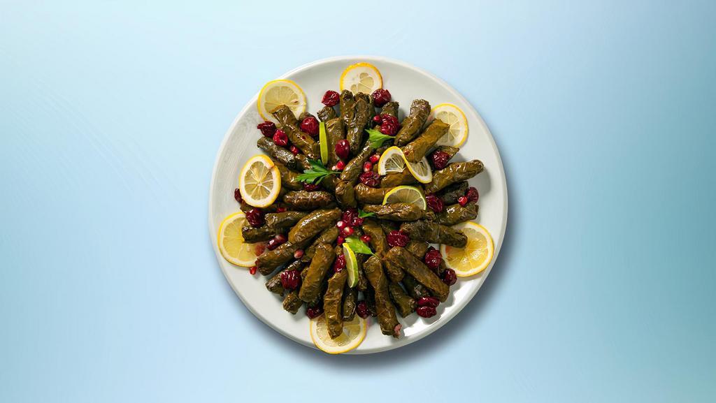 Wrapped Grape Leaves · Grape leaves Stuffed with vegetables, rice, herbs & spices served over a bed of salad.