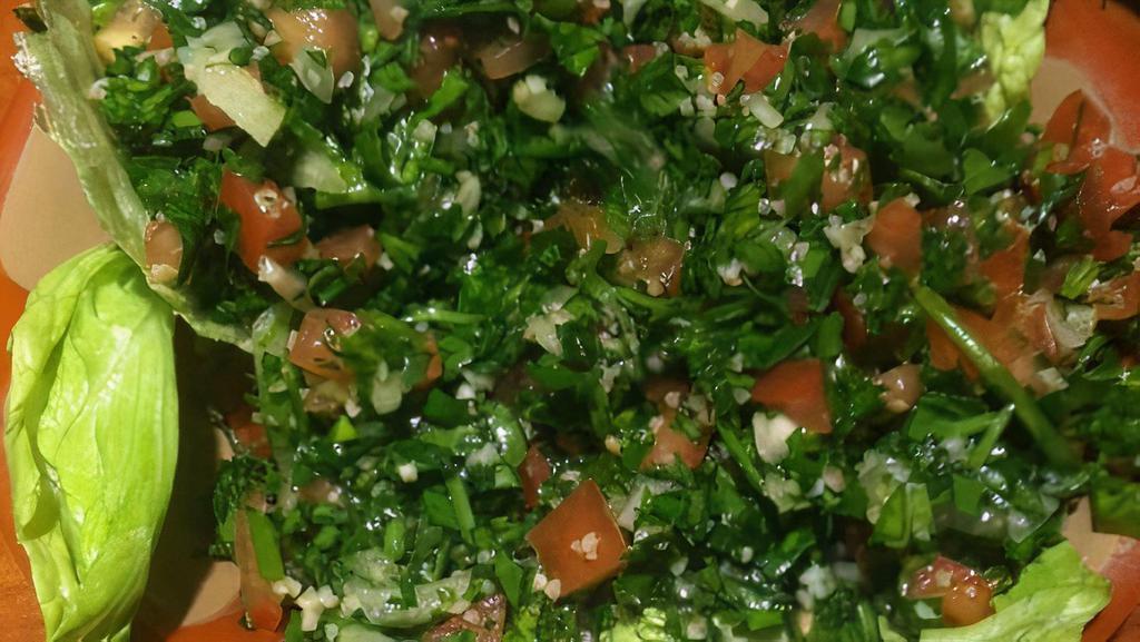 Tabouleh · Parsley, tomato, onion and cracked wheat. Tossed with lemon and olive oil.