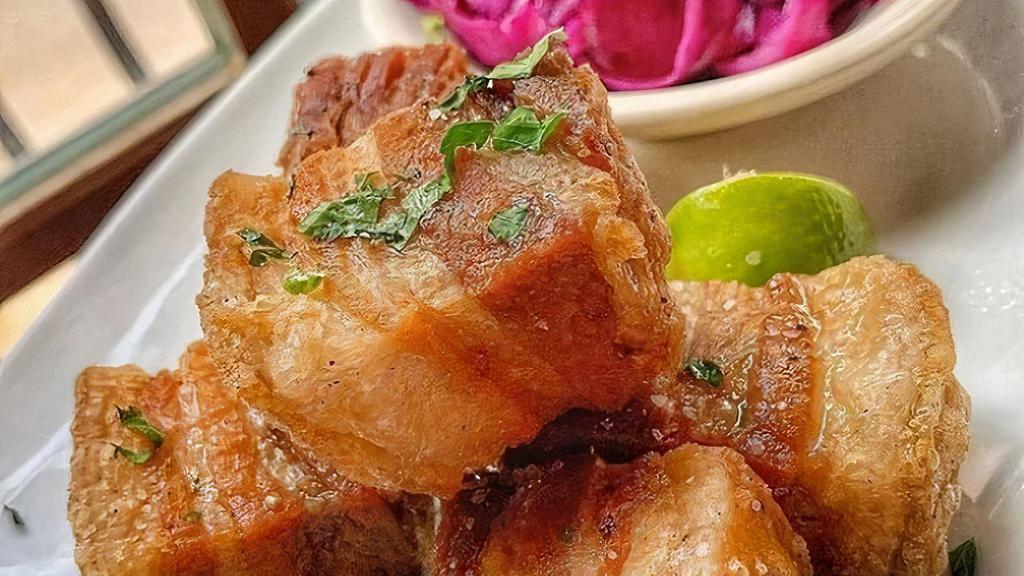 Chicharron · Cuban crispy pork belly served with tropical slaw.