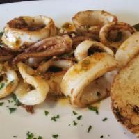 Calamares A La Parrilla · Grilled calamari in a smoked chimichurri served with grilled Cuban bread.