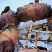 Datiles Rellenos · Bacon wrapped dates stuffed with chevre frais.