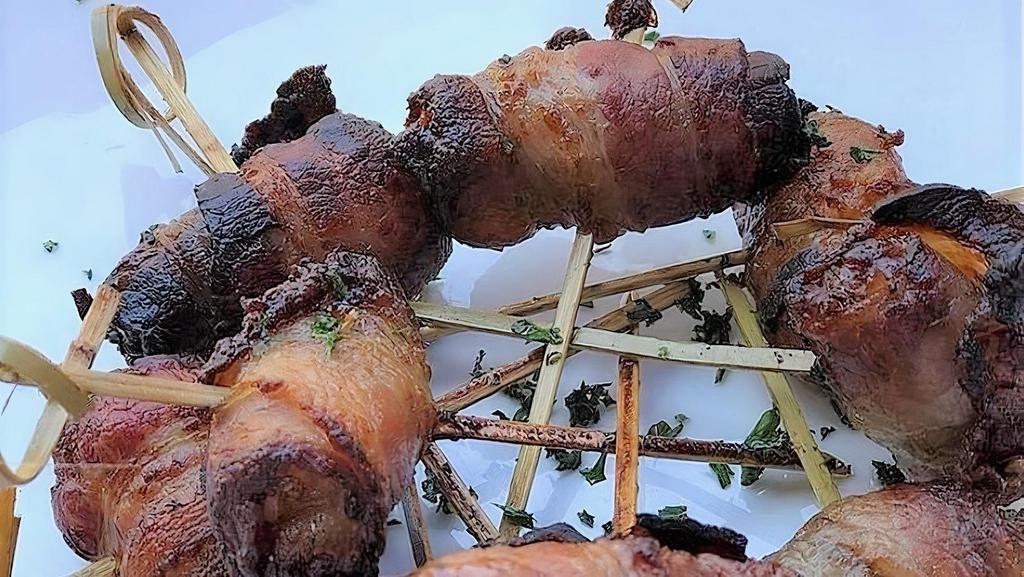 Datiles Rellenos · Bacon wrapped dates stuffed with chevre frais.