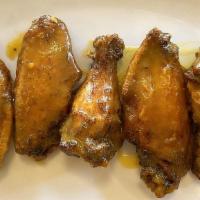 Alitas De Pollo · Crispy chicken wings in your choice of Spicy mongo habanero or Cilantro lime mojo