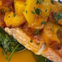 Salmon Varadero · Pan seared wild caught Atlantic salmon served with sautéed spinach and maduro chips topped w...