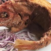 Pescado Frito · Whole fried red snapper served with mojo isleño.