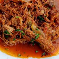 Ropa Vieja · Slow braised and shredded flank steak in a light tomato sauce with peppers and onions.