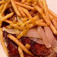 Bistec De Palomilla Con Papitas · Thin sliced sirloin topped with sautéed onions and homemade garlic fries.
