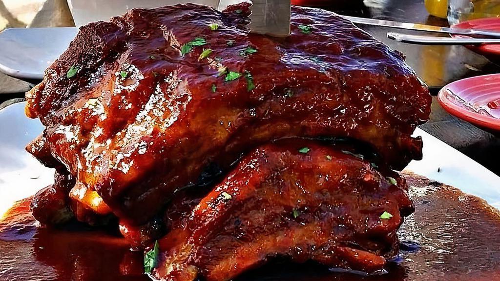 Costillas De Cerdo A La Guayaba · Falling off the bone baby back ribs smothered in our guava bbq sauce.