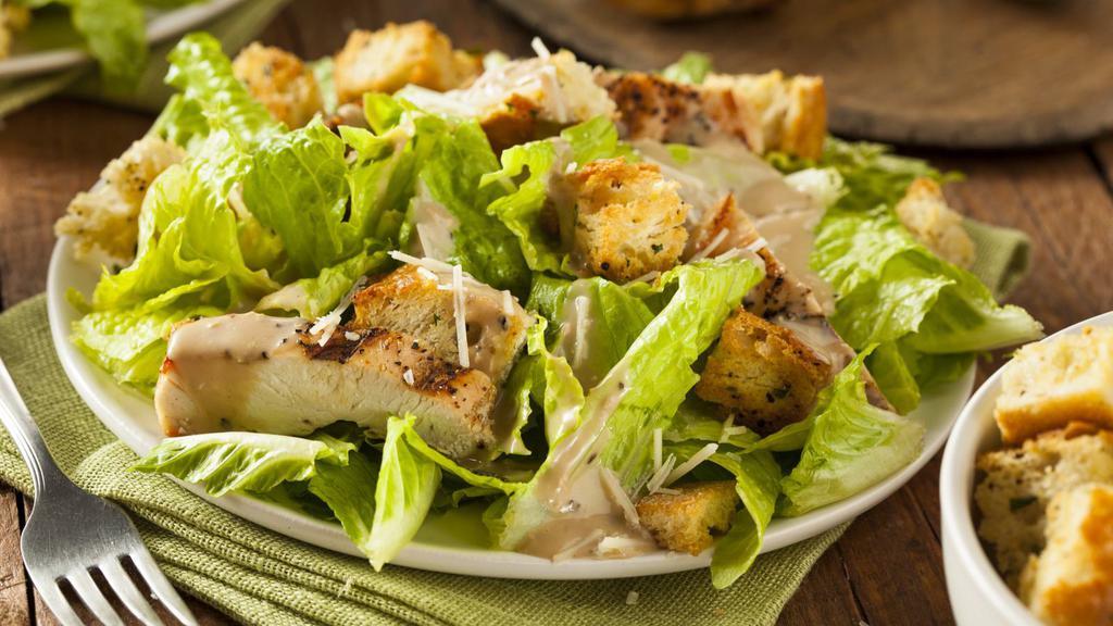 Classic Grilled Chicken Caesar Salad · Grilled chicken, romaine lettuce, garlic croutons, parmigiana cheese, grape tomatoes, creamy Caesar dressing.