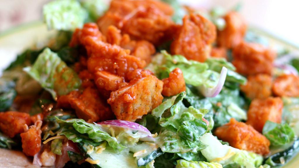 Buffalo Chicken Salad · Chicken strips tossed in buffalo sauce, romaine lettuce, garlic croutons, parmigiana cheese, fresh tomatoes, smokey chipotle dressing.