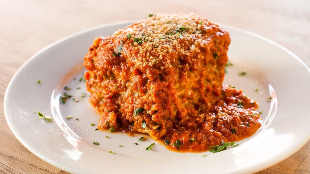 Lasagna · HOMEMADE pasta, layered with ground beef, besciamella, and tomato sauce.