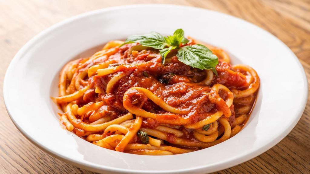 Bucatini All'Amatriciana · Bucatini pasta with pancetta, pecorino cheese and onion in tomato sauce.